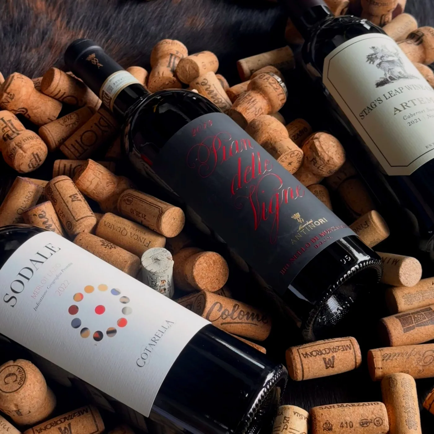 Wine bottles from the Longhorn cellar resting on a bed of corks